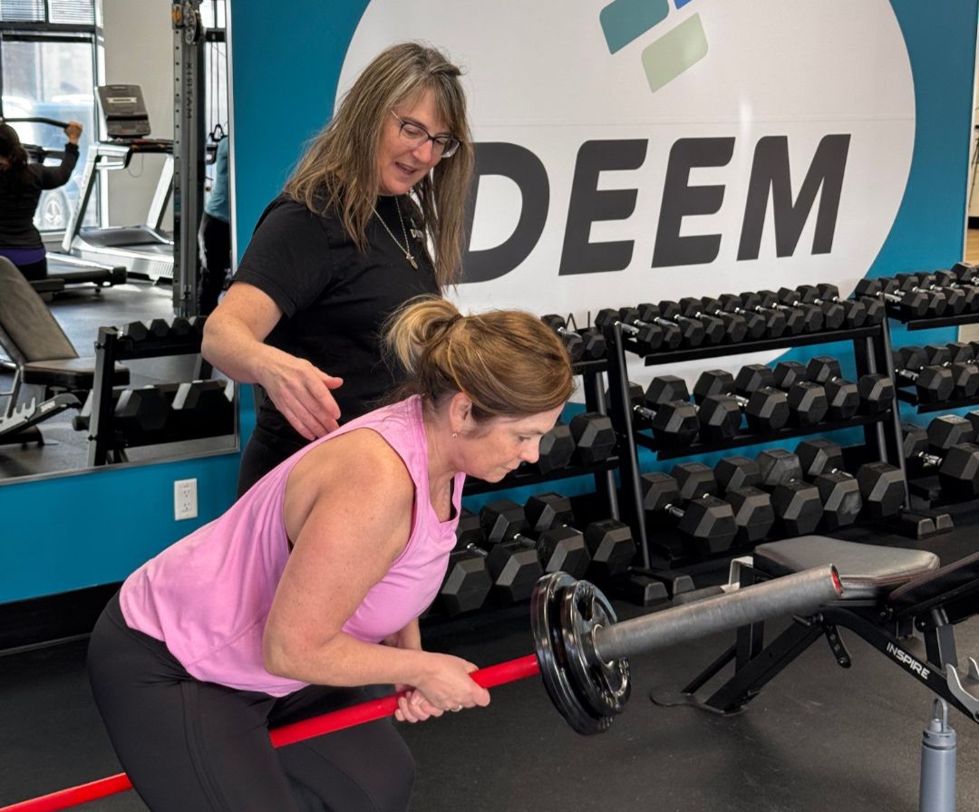 Mikkie personal training a client.
